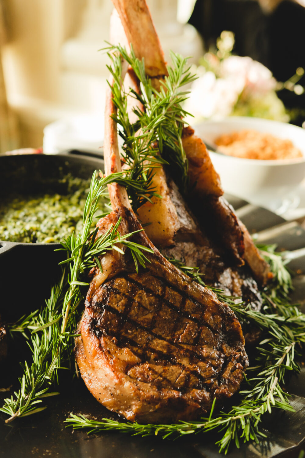edit_2978 A plate of grilled lamb chops with rosemary sprigs.