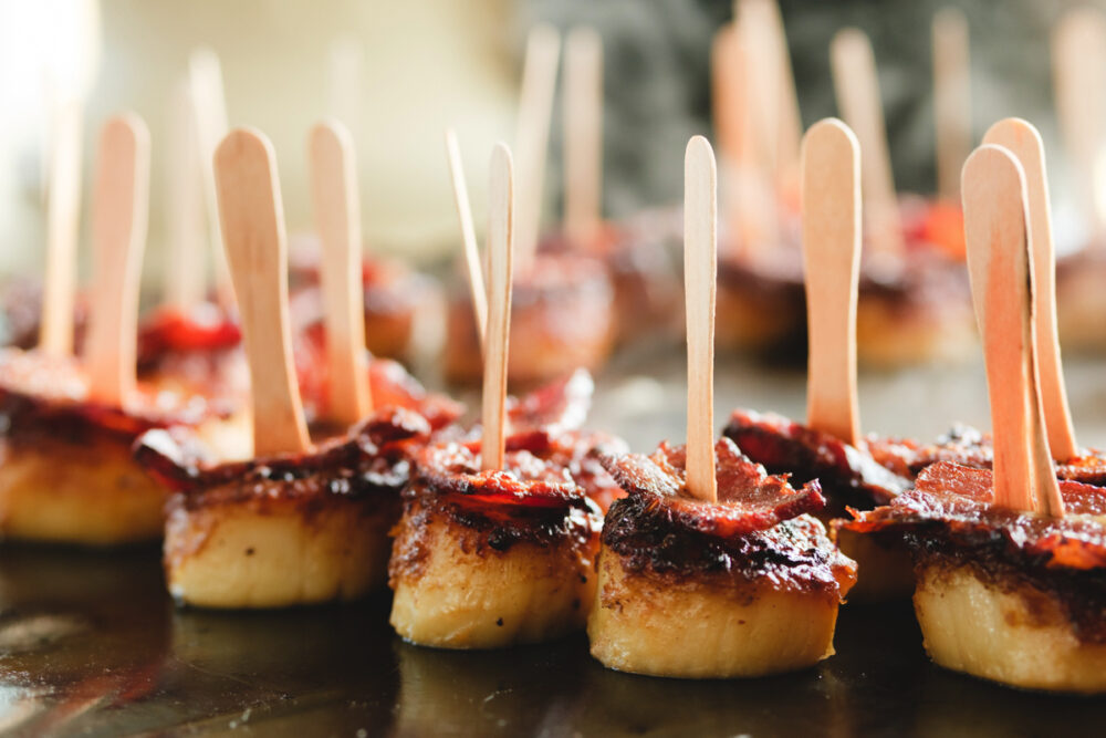 A tray of appetizers on toothpicks.