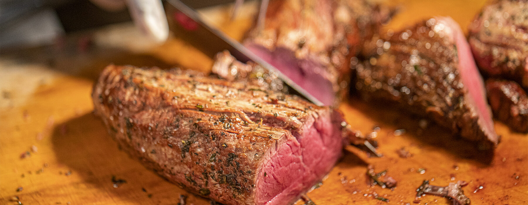 Chef carving red meat