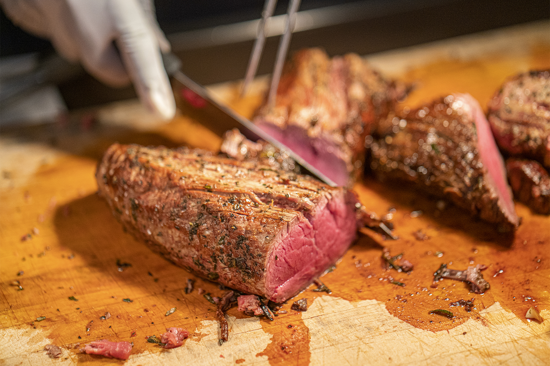 Chef carving red meat
